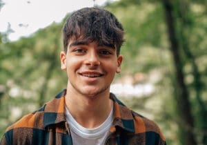 a teen smiles after impulse-control disorder treatment 
